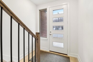 Foyer entrance with light wood-type flooring, stai