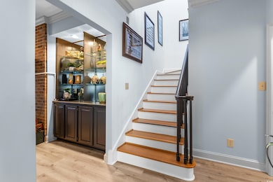 Stairs with bar area, hardwood / wood-style floori