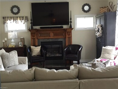 Family room has stunning  hand carved maple mantle