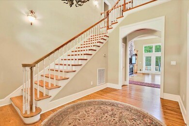 Stairs with arched walkways, wood finished floors,