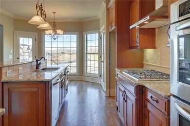 Oh and the kitchen!!! Gorgeous granite abounds, full french-style pantry and built-in wine rack snuggled among the rich wood cabinets.