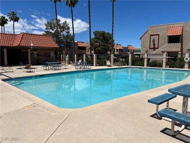 Community pool featuring fence and a patio area