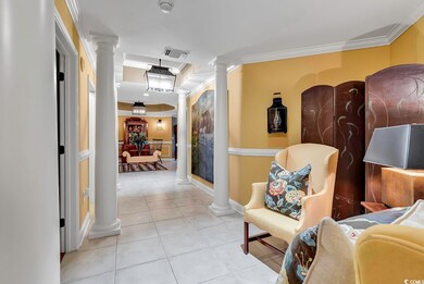 Corridor with crown molding and light tile pattern