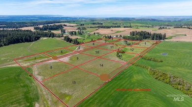 Overview of rural landscape with a mountain backdrop and property parcel outlined