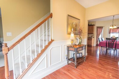 Elegant, inviting foyer boasts deep rich hardwood 