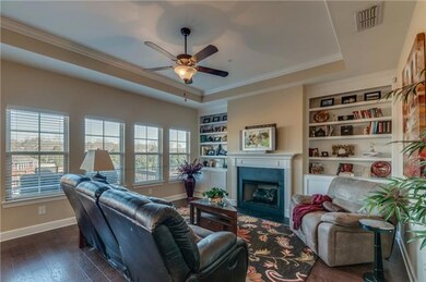 Fabulous family living features fireplace, built-ins, trey ceiling and that incredible wall of windows to take in the wonderful view!