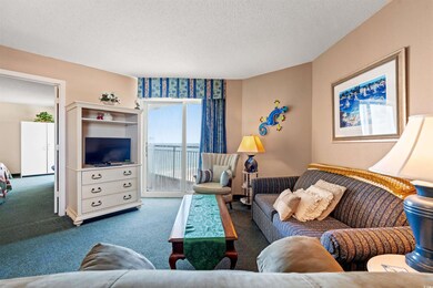 Carpeted living room featuring a textured ceiling