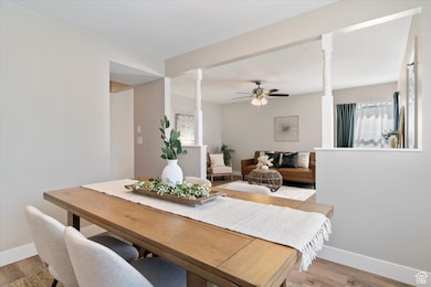 Dining space with wood finished floors and ceiling fan