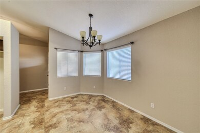 Unfurnished room with a chandelier and baseboards