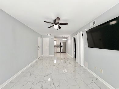 Unfurnished room featuring baseboards, marble fini