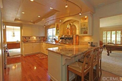 Kitchen has breakfast bar with granite counter top