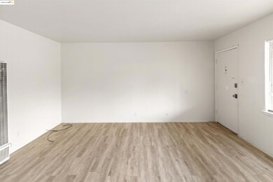 Unfurnished room featuring light wood-style floors and a heating unit