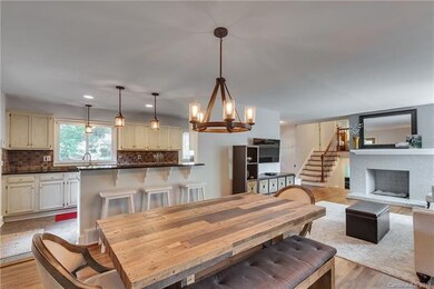 Living/dining area with decorative fireplace.