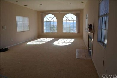 Living room with fireplace, you see hills in the b