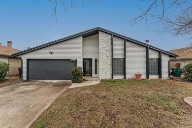 View of front of house with a garage and a front y