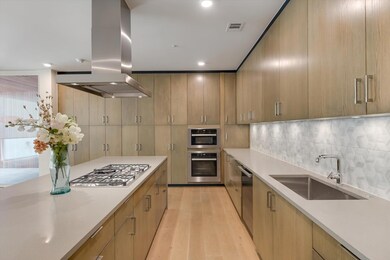 Kitchen featuring light countertops, island range