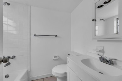 Full bathroom with tub/shower combo and white vani