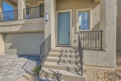 View of exterior entry featuring a garage, decorat
