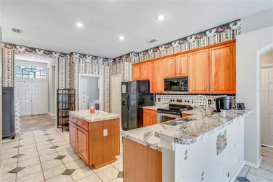 OPEN KITCHEN with WOOD CABINETS, TILED BACKSPLASH,