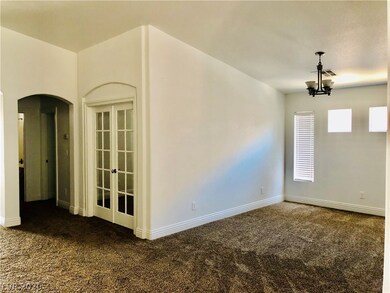 Formal dining room on right & den on left with dou