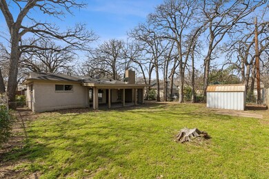 View of yard featuring a fenced backyard, a shed, 