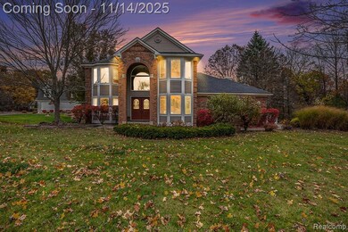 Traditional-style home with brick siding and a yard