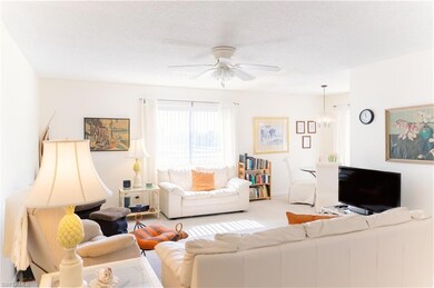 Carpeted living room featuring a textured ceiling 