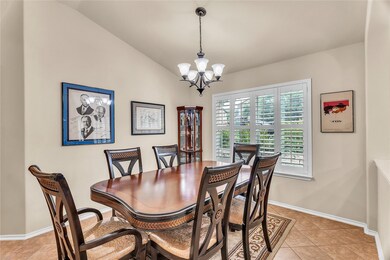 Dining room featuring a chandelier, light tile pa