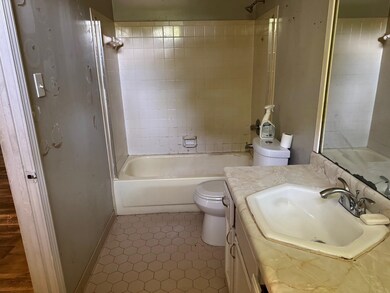 Full bath featuring toilet, tile patterned floorin