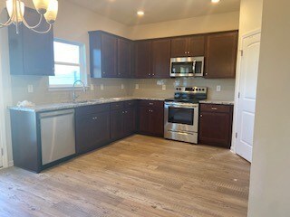 Stock photo to demonstrate plan, this home will have gray cabinets not brown