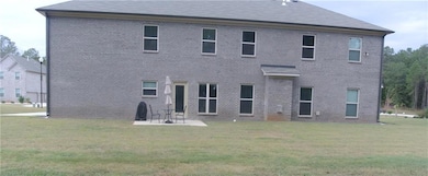Rear view of backyard lawn and patio