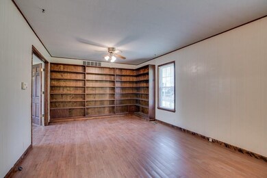 Built in bookcases in the den; it opens to formal