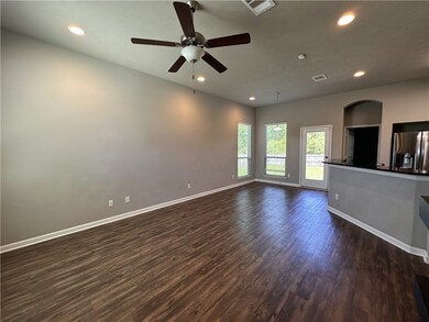 Unfurnished living room with dark wood-type floori