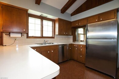 This kitchen has lots of cabinets and openings for you to be able to communicate with your family or entertain guest while preparing their meals