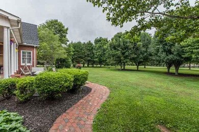 Beautiful brick sidewalk leading around to your porch.