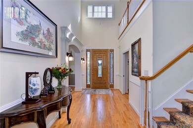 Two story foyer with views of the private backyard