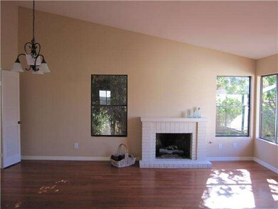 Gleaming wood-like laminate floors and fireplace a