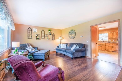 Inside, the bright and airy living room welcomes you with a large picture window and beautiful laminate floors.