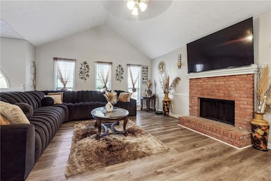 Living room with ceiling fan, lofted ceiling, a br