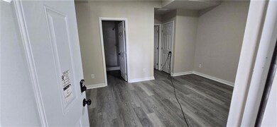 Unfurnished bedroom with baseboards, connected bat