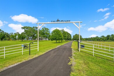 Gated entrance to the property with new asphalt dr