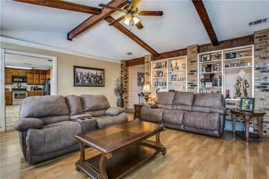 Large den with great features like the beams, bric