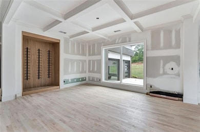 Pretty dining room with coffered ceiling and unique wine storage
