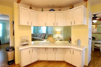 Kitchen with crown molding, hardwood / wood-style
