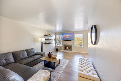 Living area with hardwood / wood-style flooring and a fireplace