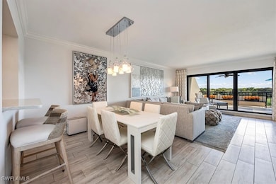 Dining room with ornamental molding and wood finish floors