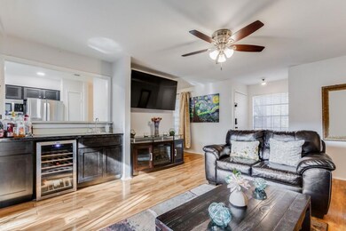 Living room with ceiling fan, light hardwood / woo