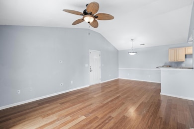 Unfurnished living room with lofted ceiling, light