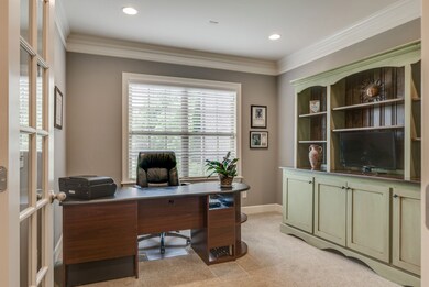 Office with crown molding and French doors.