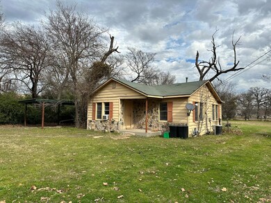 View of front of property with a front lawn, centr